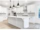 Modern kitchen with white cabinets, stainless steel appliances, a spacious island, and stylish pendant lighting at 236 Wheatfield Dr # 102P, Statesville, NC 28677