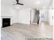 Bright, open living room with fireplace, ceiling fan and light wood-look flooring at 236 Wheatfield Dr # 102P, Statesville, NC 28677