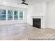 Open living room featuring a fireplace, large windows, and contemporary ceiling fan at 236 Wheatfield Dr # 102P, Statesville, NC 28677