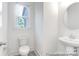 Clean, modern powder room with white fixtures and ample natural light at 236 Wheatfield Dr # 102P, Statesville, NC 28677