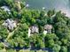 Aerial shot of properties nestled among lush trees with lake access at 258 Patterson'S Bridge None, New London, NC 28127
