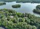 Expansive aerial view showcasing the property's wooded lot and lake access at 258 Patterson'S Bridge None, New London, NC 28127