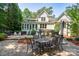 Outdoor patio with a dining set, perfect for entertaining, with a screened-in porch and lush backyard in the background at 258 Patterson'S Bridge None, New London, NC 28127