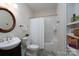 Bathroom featuring tub with shower, toilet, and vanity with round mirror at 258 Patterson'S Bridge None, New London, NC 28127