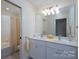 Bright bathroom featuring double vanity with large mirror and a combined tub and shower at 258 Patterson'S Bridge None, New London, NC 28127