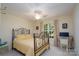 Bedroom featuring a metal bed frame, ceiling fan, and large window with curtains at 258 Patterson'S Bridge None, New London, NC 28127