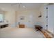 Spacious bonus room with neutral carpet, built-in bench, and half wall wainscoting detail at 258 Patterson'S Bridge None, New London, NC 28127