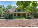 Charming home with stone accents, inviting front porch, lush landscaping, and manicured lawn at 258 Patterson'S Bridge None, New London, NC 28127