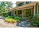 Inviting front porch with stone walkway, lush landscaping, and a charming green front door at 258 Patterson'S Bridge None, New London, NC 28127