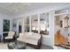 Sun room with large windows showcasing a living area and staircase inside the home, creating a bright and inviting space at 258 Patterson'S Bridge None, New London, NC 28127
