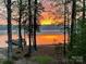Scenic waterfront view at sunset with a private dock and tranquil lake reflecting the warm colors at 258 Patterson'S Bridge None, New London, NC 28127
