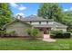 Spacious backyard featuring a brick patio, lush lawn, and mature trees at 2709 Wamath Dr, Charlotte, NC 28210