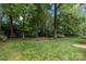 Expansive backyard with mature trees, offering a private and serene outdoor space at 2709 Wamath Dr, Charlotte, NC 28210