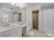 Bathroom featuring double sink vanity, shower stall, and tile flooring at 2709 Wamath Dr, Charlotte, NC 28210