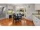 Bright dining area featuring wood floors, granite counters, breakfast bar, and view of the outdoor patio at 2709 Wamath Dr, Charlotte, NC 28210