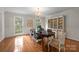 Elegant dining room featuring hardwood floors, ample natural light, and decorative wainscoting at 2709 Wamath Dr, Charlotte, NC 28210
