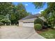 Spacious three-car garage with a basketball hoop and well-maintained landscaping at 2709 Wamath Dr, Charlotte, NC 28210