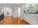 Hallway featuring hardwood floors, white cabinets, and wet bar at 2709 Wamath Dr, Charlotte, NC 28210