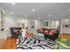 Bright living room with hardwood floors, zebra rug, and grey sofa at 2709 Wamath Dr, Charlotte, NC 28210