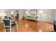 Bright living room with hardwood floors, a floral sofa, and a view into an adjacent room at 2709 Wamath Dr, Charlotte, NC 28210