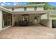 Spacious brick patio features a covered seating area, perfect for outdoor relaxation and entertaining at 2709 Wamath Dr, Charlotte, NC 28210