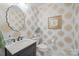Stylish powder room with unique wallpaper and marble countertop at 2709 Wamath Dr, Charlotte, NC 28210