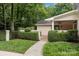 Charming side yard with manicured hedges and a brick pathway leading to the entrance at 2709 Wamath Dr, Charlotte, NC 28210