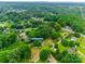 Drone shot of property at 2921 Ambrose Dr with surrounding area of lush trees, greenery and a quiet neighborhood at 2921 Ambrose Dr, Gastonia, NC 28056