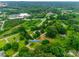 Expansive aerial view of the property nestled among lush greenery, with the house located at 2921 Ambrose Dr at 2921 Ambrose Dr, Gastonia, NC 28056