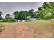 Spacious backyard features lush green grass, mature trees, and outbuildings at 2921 Ambrose Dr, Gastonia, NC 28056