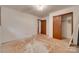 A bedroom with unfinished floors, a single window and a closet ready to be customized at 2921 Ambrose Dr, Gastonia, NC 28056