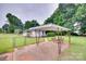 Carport area of the property featuring a metal structure and a small green yard at 2921 Ambrose Dr, Gastonia, NC 28056