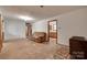 A living room with unfinished floors, connections to other rooms and minimal decor at 2921 Ambrose Dr, Gastonia, NC 28056
