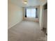 Bright, carpeted bedroom with a window featuring dark curtains, perfect for a cozy retreat at 300 N Watterson St, Kings Mountain, NC 28086