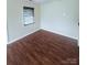 Cozy bedroom featuring hardwood floors, neutral walls, and a bright window at 300 N Watterson St, Kings Mountain, NC 28086