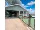 View of the covered carport and front entry, enhanced by a well-kept, fenced yard at 300 N Watterson St, Kings Mountain, NC 28086