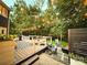 Spacious backyard with a multi-level deck, seating, fire pit, and lush greenery, perfect for outdoor living at 3314 Mara Ct, Matthews, NC 28105