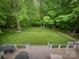 Aerial view of a large, lush backyard from the deck, with string lights and seating areas for entertaining at 3314 Mara Ct, Matthews, NC 28105
