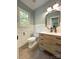 Charming bathroom with wood-look tile floors, wainscoting, and a modern vanity with a marble countertop at 3314 Mara Ct, Matthews, NC 28105