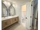 Stylish bathroom featuring dual sinks, a modern vanity, and elegant fixtures, offering a luxurious and functional space at 3314 Mara Ct, Matthews, NC 28105