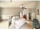 Neutral primary bedroom featuring a ceiling fan, wainscoting, and hardwood floors, providing a serene and relaxing retreat at 3314 Mara Ct, Matthews, NC 28105