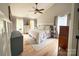 Light-filled primary bedroom with large windows, soft carpeting, and neutral tones, creating a cozy and inviting space at 3314 Mara Ct, Matthews, NC 28105