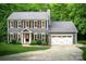 Traditional two-story home with gray siding, black shutters, a two-car garage, and well-manicured lawn at 3314 Mara Ct, Matthews, NC 28105