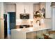 Stylish kitchen with a breakfast bar, quartz countertops, modern appliances, and white subway tile at 3314 Mara Ct, Matthews, NC 28105