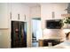 Modern kitchen featuring white cabinets, a black stainless steel refrigerator, and a subway tile backsplash at 3314 Mara Ct, Matthews, NC 28105