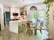 Stylish kitchen with a breakfast bar, quartz countertops, modern appliances, and access to the backyard at 3314 Mara Ct, Matthews, NC 28105