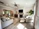 Cozy living room with a fireplace, large windows, neutral decor, and an open layout into the kitchen at 3314 Mara Ct, Matthews, NC 28105