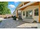 A charming home featuring a beautiful stone patio with backyard and inviting turquoise French doors to the home at 343 Melbourne Ct, Charlotte, NC 28209
