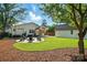 A well maintained backyard with a fire pit area, a detached garage and plenty of space for outdoor activities at 343 Melbourne Ct, Charlotte, NC 28209