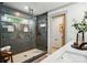 This bathroom features an elegant glass shower with gray tile and modern fixtures and accents at 343 Melbourne Ct, Charlotte, NC 28209
